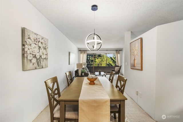 dining space featuring light colored carpet and a textured ceiling