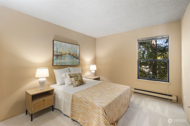 carpeted bedroom with a baseboard radiator and a textured ceiling