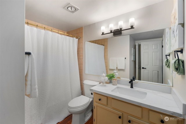 bathroom with vanity, curtained shower, and toilet