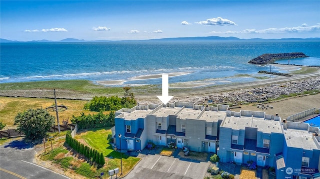 drone / aerial view with a water view and a beach view