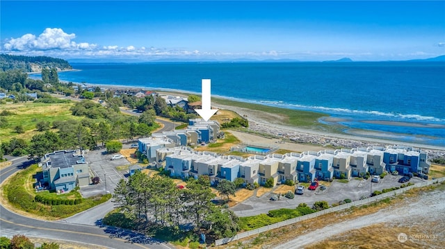 aerial view with a water view, a residential view, and a view of the beach