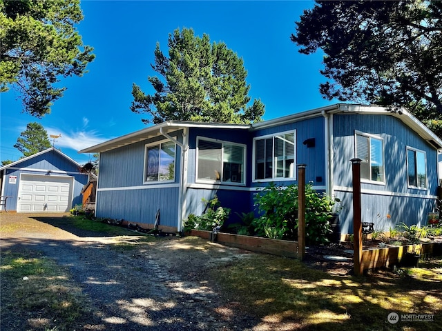 view of front of house with a garage and an outdoor structure