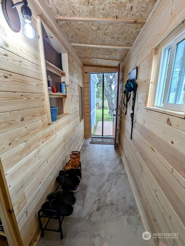 interior space with wooden walls and concrete floors