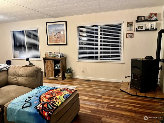 living room featuring hardwood / wood-style floors and a wood stove