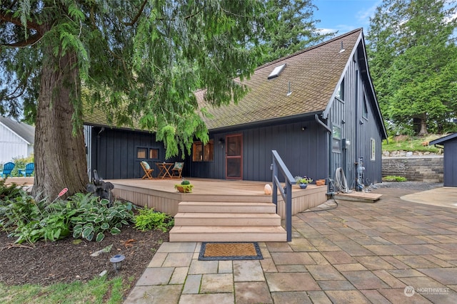 back of property featuring a wooden deck