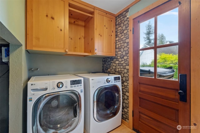 laundry room with cabinets and washer and clothes dryer