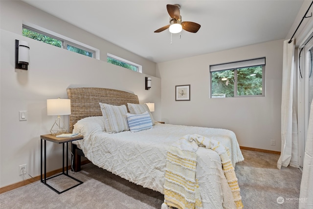 bedroom featuring light colored carpet and ceiling fan