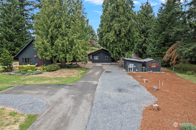 view of front of house with an outbuilding and a front yard