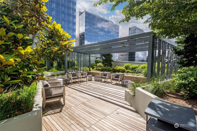 wooden terrace featuring a pergola and outdoor lounge area