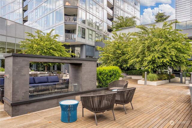 wooden terrace featuring outdoor lounge area