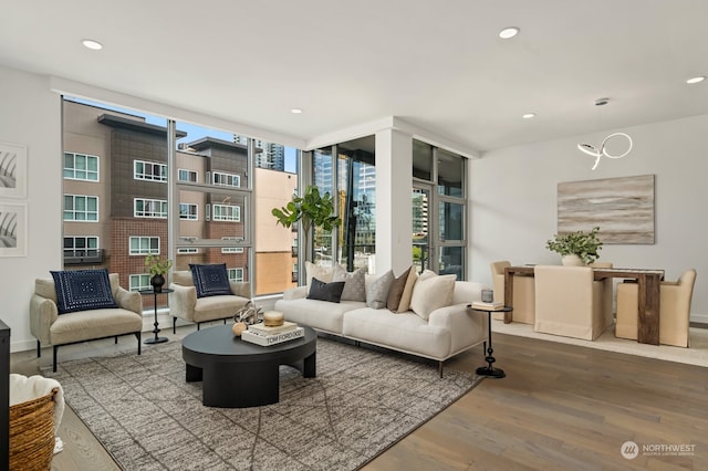 living area with a wall of windows and hardwood / wood-style floors