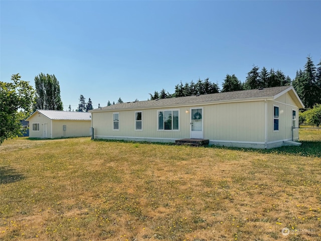 rear view of property with a yard