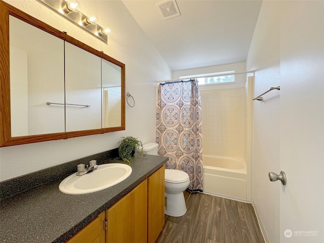 full bathroom with vanity, toilet, shower / bath combo with shower curtain, and hardwood / wood-style flooring