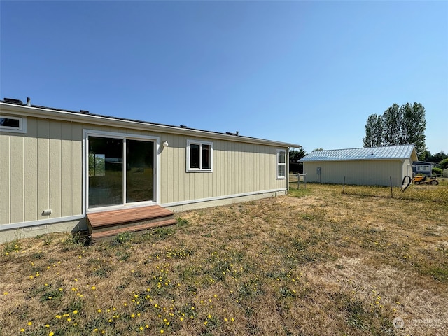 back of property featuring a lawn