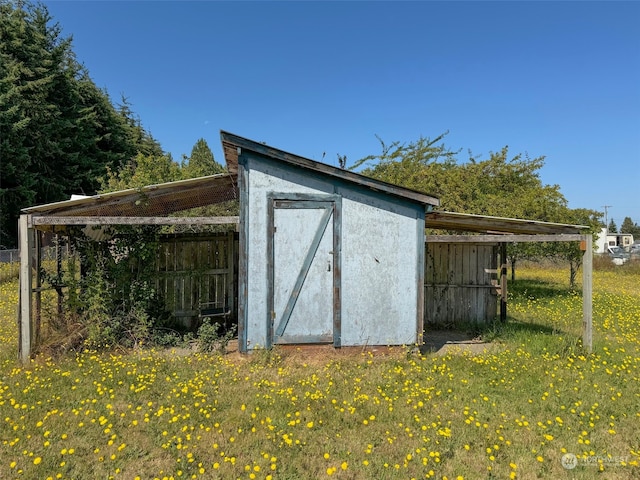 view of outdoor structure with a lawn