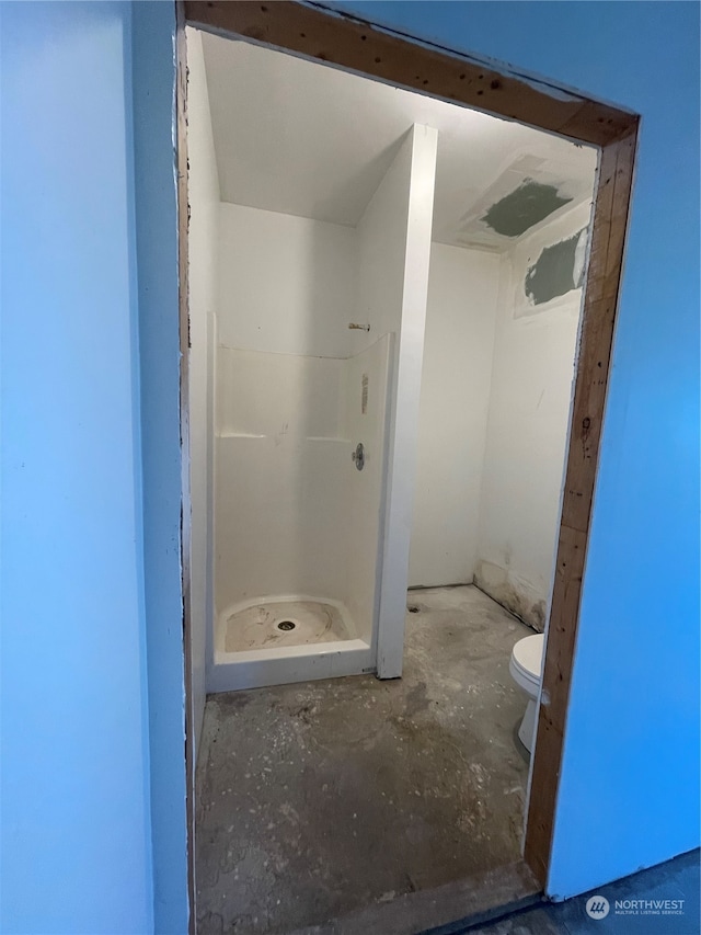 bathroom with walk in shower and toilet