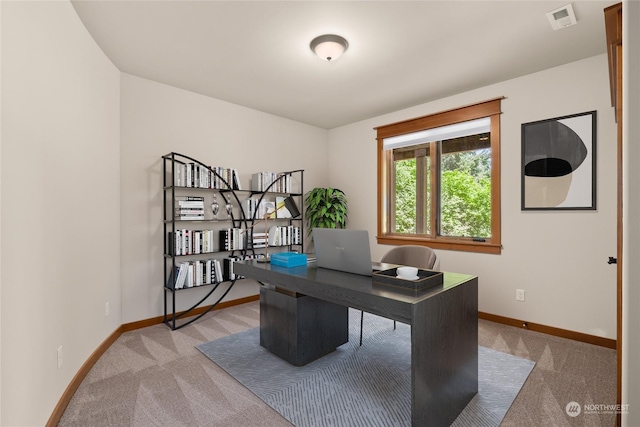 office area featuring visible vents, light carpet, and baseboards