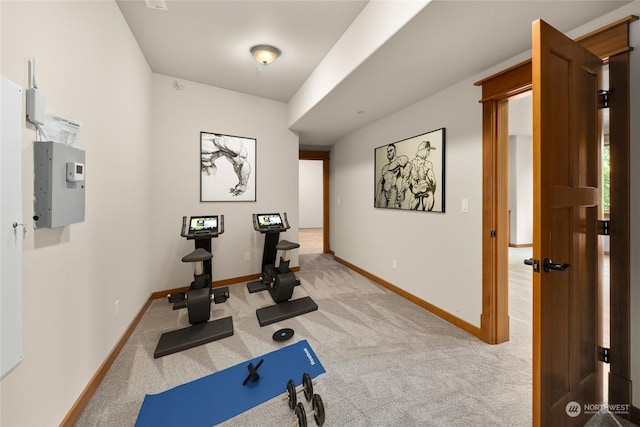 workout area featuring carpet flooring and baseboards