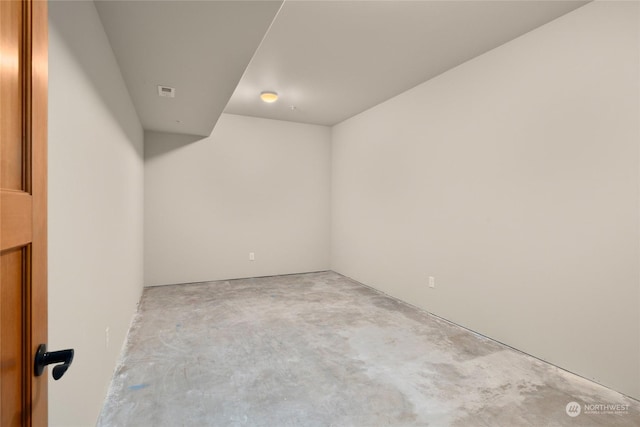 empty room with unfinished concrete flooring and visible vents