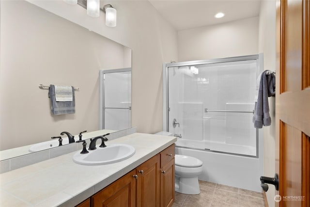 full bath with toilet, recessed lighting, vanity, combined bath / shower with glass door, and tile patterned floors