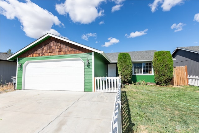 ranch-style home with a garage and a front lawn