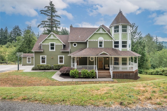 victorian house with covered porch and a front lawn