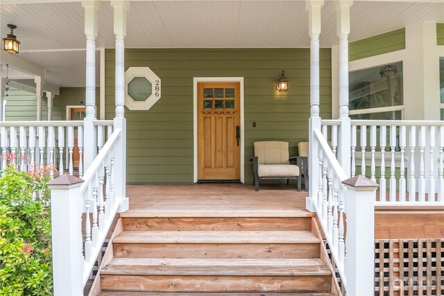 view of exterior entry with a porch