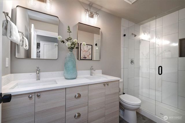 bathroom featuring vanity, toilet, and walk in shower