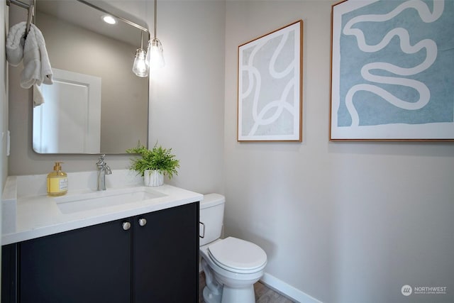 bathroom featuring vanity and toilet