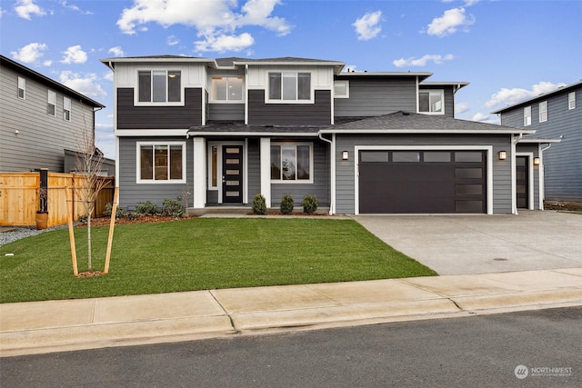 view of front of house featuring a garage and a front lawn