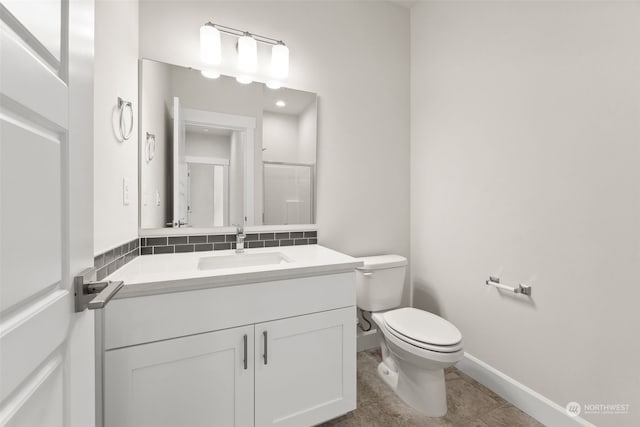 bathroom featuring vanity, backsplash, and toilet