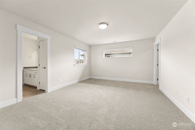 spare room featuring light colored carpet