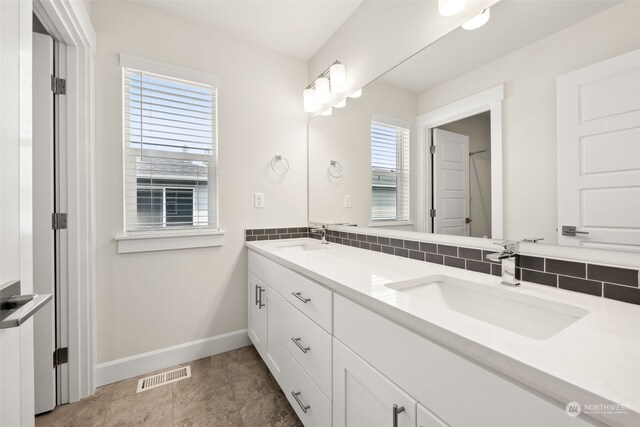 bathroom with vanity and backsplash