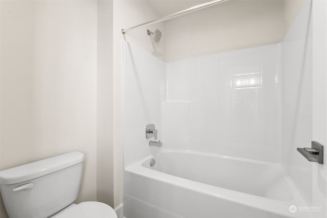 bathroom featuring washtub / shower combination and toilet