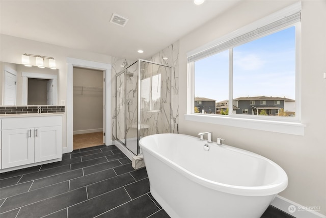 bathroom with tile patterned floors, vanity, and independent shower and bath