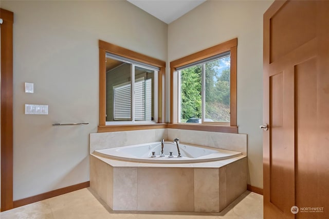 bathroom with tile patterned floors and tiled bath