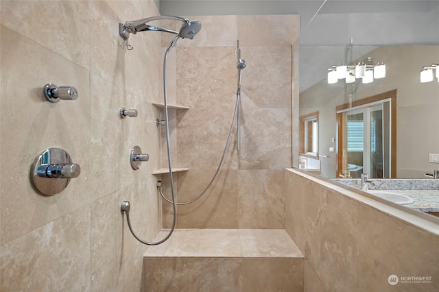 bathroom featuring sink and a tile shower