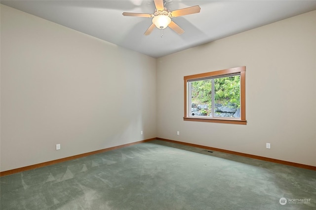 spare room featuring ceiling fan and carpet flooring