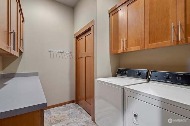 washroom with separate washer and dryer and cabinets