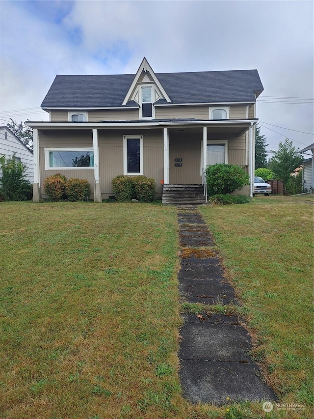 view of front of house with covered porch and a front yard