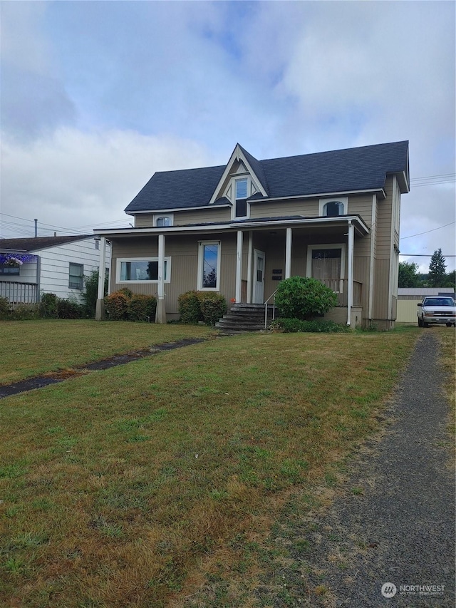 view of front of home with a front yard and covered porch