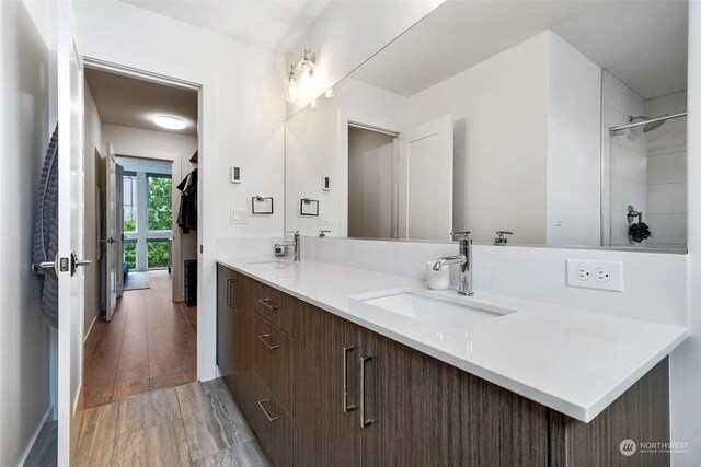 bathroom featuring double vanity and hardwood / wood-style floors