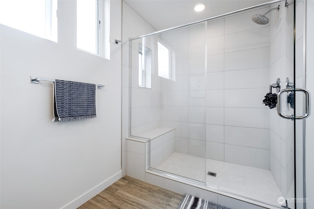 bathroom featuring walk in shower and wood-type flooring