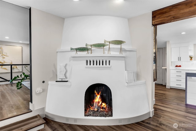 interior space featuring dark hardwood / wood-style floors and a large fireplace