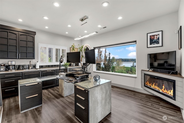 kitchen featuring dark brown cabinets, dark hardwood / wood-style floors, and a kitchen island