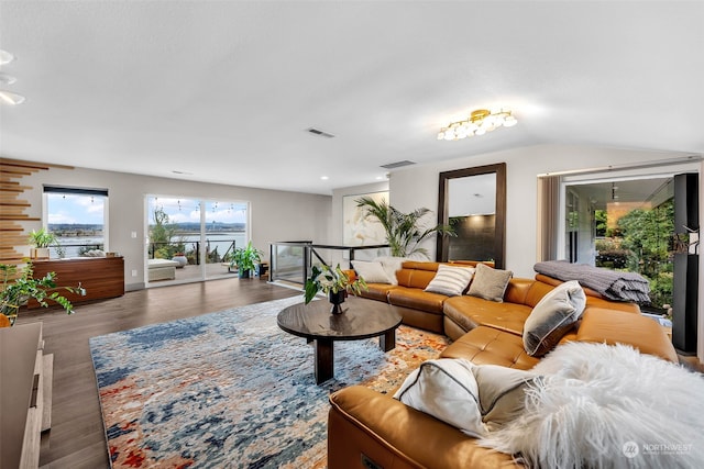 living room featuring wood-type flooring and lofted ceiling