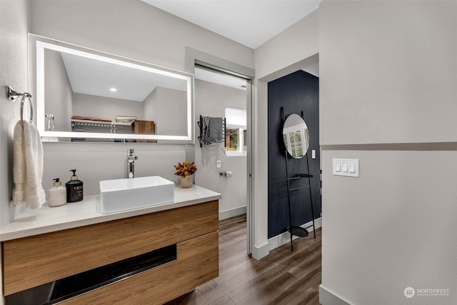 bathroom with vanity and hardwood / wood-style flooring