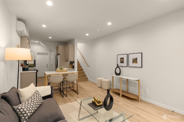 living room featuring light wood-type flooring and a wall mounted AC