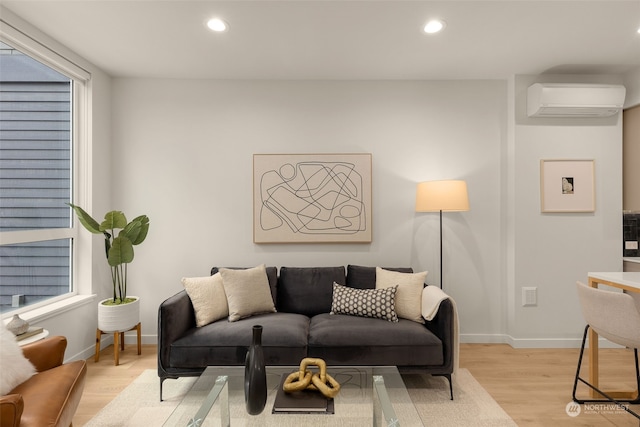 living room with light wood-type flooring and a wall mounted air conditioner