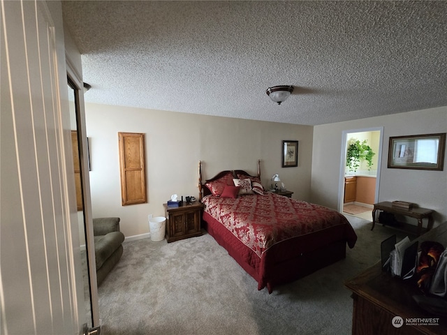 bedroom featuring light colored carpet and a textured ceiling